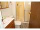 Bathroom features a vanity, toilet, a walk-in shower with glass doors, and a light fixture at 7838 Burr Oak Ct, Indianapolis, IN 46217