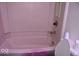 Bathroom featuring a classic toilet and bathtub with shower, offering essential amenities at 7838 Burr Oak Ct, Indianapolis, IN 46217