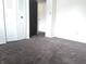 Bedroom with neutral carpet, featuring double closets and another room in the background at 7838 Burr Oak Ct, Indianapolis, IN 46217