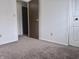 Bedroom featuring neutral carpet and a view into the room through a partially-open doorway at 7838 Burr Oak Ct, Indianapolis, IN 46217