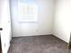 Comfortable bedroom with a window, neutral carpet, and white walls, a cozy retreat at 7838 Burr Oak Ct, Indianapolis, IN 46217