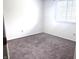 Bright bedroom featuring a window, neutral carpet, and white walls, a blank canvas at 7838 Burr Oak Ct, Indianapolis, IN 46217