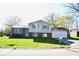 Charming split-level home with a well-maintained lawn and an attached two-car garage at 7838 Burr Oak Ct, Indianapolis, IN 46217