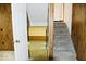 Hallway with a view to stairs, panelling, a light-colored carpet, and view to other spaces at 7838 Burr Oak Ct, Indianapolis, IN 46217