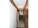 View of hallway with wood paneling and stairs leading to the upper level at 7838 Burr Oak Ct, Indianapolis, IN 46217