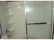 Shower with sliding glass doors and built-in shelves for storage at 7838 Burr Oak Ct, Indianapolis, IN 46217