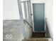 Stairway leading to the basement with carpeted steps and gray railing at 7838 Burr Oak Ct, Indianapolis, IN 46217