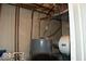 Utility room featuring a modern water heater with essential plumbing and electrical connections at 7838 Burr Oak Ct, Indianapolis, IN 46217