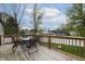 Wooden deck with patio furniture, overlooking trees, creating a perfect outdoor dining and relaxation area at 8231 N Chaucer Ct, Columbus, IN 47201