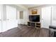 Basement entertainment area with sleek wood floors, a large screen television, and a fireplace at 8231 N Chaucer Ct, Columbus, IN 47201