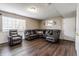 Finished basement featuring a large sectional sofa, recliner, and a window offering natural light at 8231 N Chaucer Ct, Columbus, IN 47201