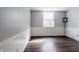 Basement living area with wood-look floors, white trim, and a bright window for natural light at 8231 N Chaucer Ct, Columbus, IN 47201