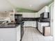 Bright kitchen featuring stainless steel appliances, white cabinetry, and an adjacent dining area at 8231 N Chaucer Ct, Columbus, IN 47201