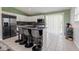 Well-lit kitchen showcases modern appliances, breakfast bar with seating, and a sliding door to the outside at 8231 N Chaucer Ct, Columbus, IN 47201