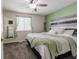 Comfortable bedroom featuring soft carpeting, a ceiling fan, a statement headboard, and natural lighting at 8231 N Chaucer Ct, Columbus, IN 47201