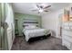 Cozy bedroom featuring a full bed, a ceiling fan, and a decorative dresser at 8231 N Chaucer Ct, Columbus, IN 47201