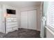 Well-lit bedroom offering a large dresser and closet with ample storage space at 8231 N Chaucer Ct, Columbus, IN 47201