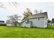 Expansive backyard showcases lush green lawn, well-maintained siding, and additional structure at 831 N 12Th St, Elwood, IN 46036