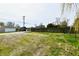 Spacious backyard area with grass, a detached garage, and a fence, offering ample space for outdoor activities at 831 N 12Th St, Elwood, IN 46036
