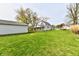 Expansive backyard with lush green lawn, detached garage, and well-maintained surrounding landscape at 831 N 12Th St, Elwood, IN 46036