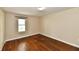 Empty bedroom with hardwood floors, a window, fresh paint and one light on the ceiling at 831 N 12Th St, Elwood, IN 46036