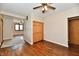 Bedroom with hardwood floors, closet with wood doors, and a view into another room at 831 N 12Th St, Elwood, IN 46036