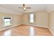 Sun-filled room with wood floors, two windows, and a ceiling fan for lots of natural light and comfort at 831 N 12Th St, Elwood, IN 46036