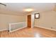 Bright bedroom featuring wood floors, a closet with sliding doors and a small window offering natural light at 831 N 12Th St, Elwood, IN 46036