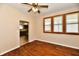 Bedroom features hardwood floors, window with wood trim and a view into the kitchen at 831 N 12Th St, Elwood, IN 46036