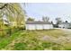 Large detached three-car garage featuring a well-maintained exterior and a gravel driveway at 831 N 12Th St, Elwood, IN 46036