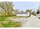 Large detached three-car garage featuring a well-maintained exterior and a gravel driveway at 831 N 12Th St, Elwood, IN 46036