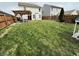 Spacious backyard featuring a wooden pergola, lawn, and full fencing at 8333 Sansa St, Indianapolis, IN 46113