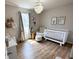 Charming Bedroom with hardwood floors, white crib, chandelier, and giraffe decorations at 8333 Sansa St, Indianapolis, IN 46113