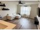 Bright living room with a white sectional, modern lighting and floating shelves at 8333 Sansa St, Indianapolis, IN 46113
