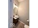 Stylish powder room featuring a vessel sink and unique lighting fixture at 8333 Sansa St, Indianapolis, IN 46113