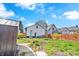 Exterior rear of home featuring lush backyard with shed, and fenced yard at 835 N Dearborn St, Indianapolis, IN 46201