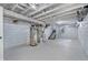 Unfinished basement featuring painted block walls, open ceiling, and mechanical systems, ready for customization at 835 N Dearborn St, Indianapolis, IN 46201