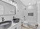 Modern bathroom features double black vessel sinks and white tiled shower with niche at 835 N Dearborn St, Indianapolis, IN 46201