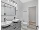 Bathroom with dual sinks, a tiled shower with rain shower head, and modern fixtures at 835 N Dearborn St, Indianapolis, IN 46201