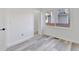 Bright bedroom features a window, door, and stylish gray wood-look flooring at 835 N Dearborn St, Indianapolis, IN 46201