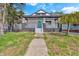 Charming home featuring a welcoming front porch, fresh paint, and a well-maintained front yard at 835 N Dearborn St, Indianapolis, IN 46201