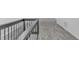 Upstairs hallway featuring neutral carpeting and dark metal railing at 835 N Dearborn St, Indianapolis, IN 46201