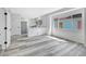 Bright, modern living room with gray floors, fresh paint, and an open view to the kitchen at 835 N Dearborn St, Indianapolis, IN 46201