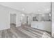 Bright, open-concept living room and kitchen with new gray flooring and recessed lighting at 835 N Dearborn St, Indianapolis, IN 46201