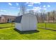 Backyard featuring a storage shed, lawn, and chainlink fence at 84 Beech Ct, Whiteland, IN 46184