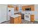 Inviting kitchen with white appliances and island, providing a functional and stylish cooking space at 84 Beech Ct, Whiteland, IN 46184