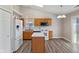 Bright kitchen with an island, white appliances and a sliding door to backyard at 84 Beech Ct, Whiteland, IN 46184