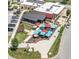 Aerial view of a lively outdoor dining area with colorful umbrellas, surrounded by lush greenery and parking at 8740 Morgan Dr, Fishers, IN 46038