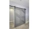 Close-up of gray barn door showing its decorative geometric paneling in a modern interior at 8740 Morgan Dr, Fishers, IN 46038