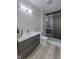 Modern bathroom featuring a sleek vanity, glass-enclosed shower with textured tile, and contemporary fixtures at 8740 Morgan Dr, Fishers, IN 46038